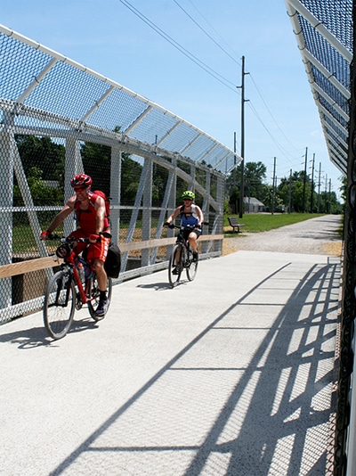 Two cyclists travel across the new Katy Trail Bridge in Sedalia