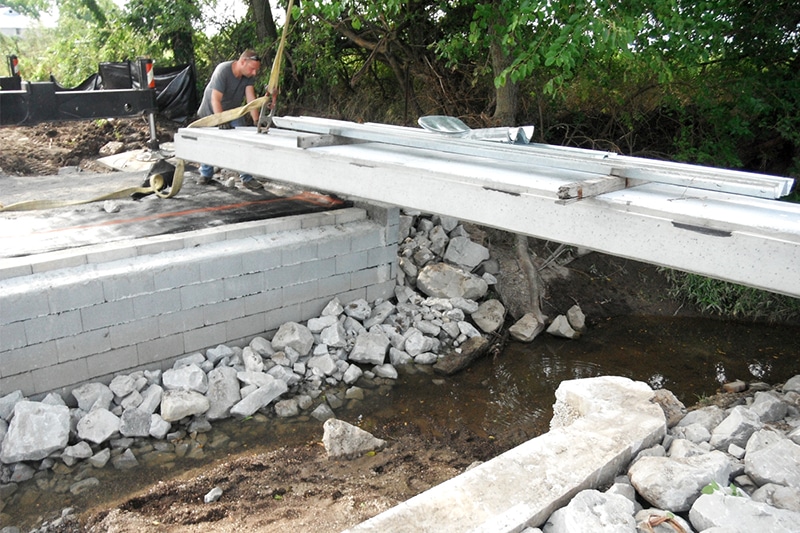 Bridge planks set in place on geosynthetic reinfornced soil integrated bridge system
