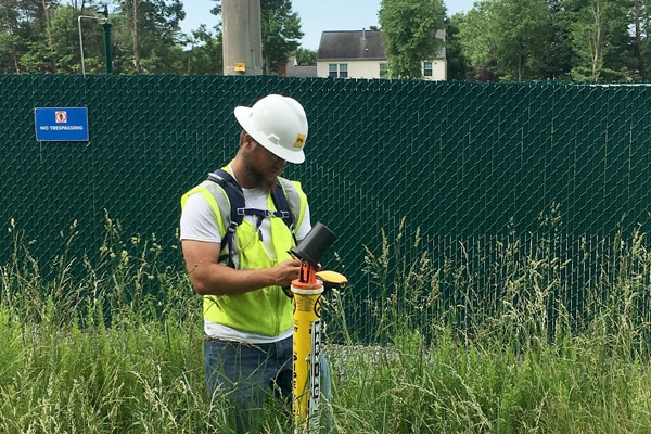 SKW Intern Aaron Holderness works with equipment on a project site in Virginia.