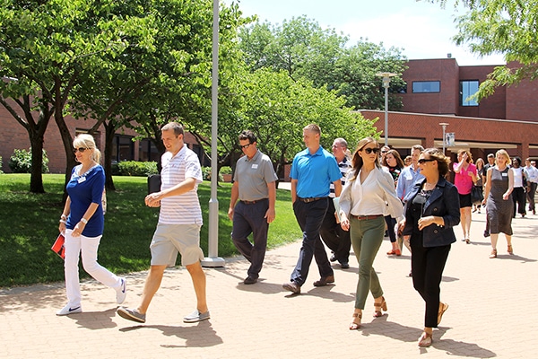 Tyson walks on sidewalk with her Leadership Overland Park classmates.