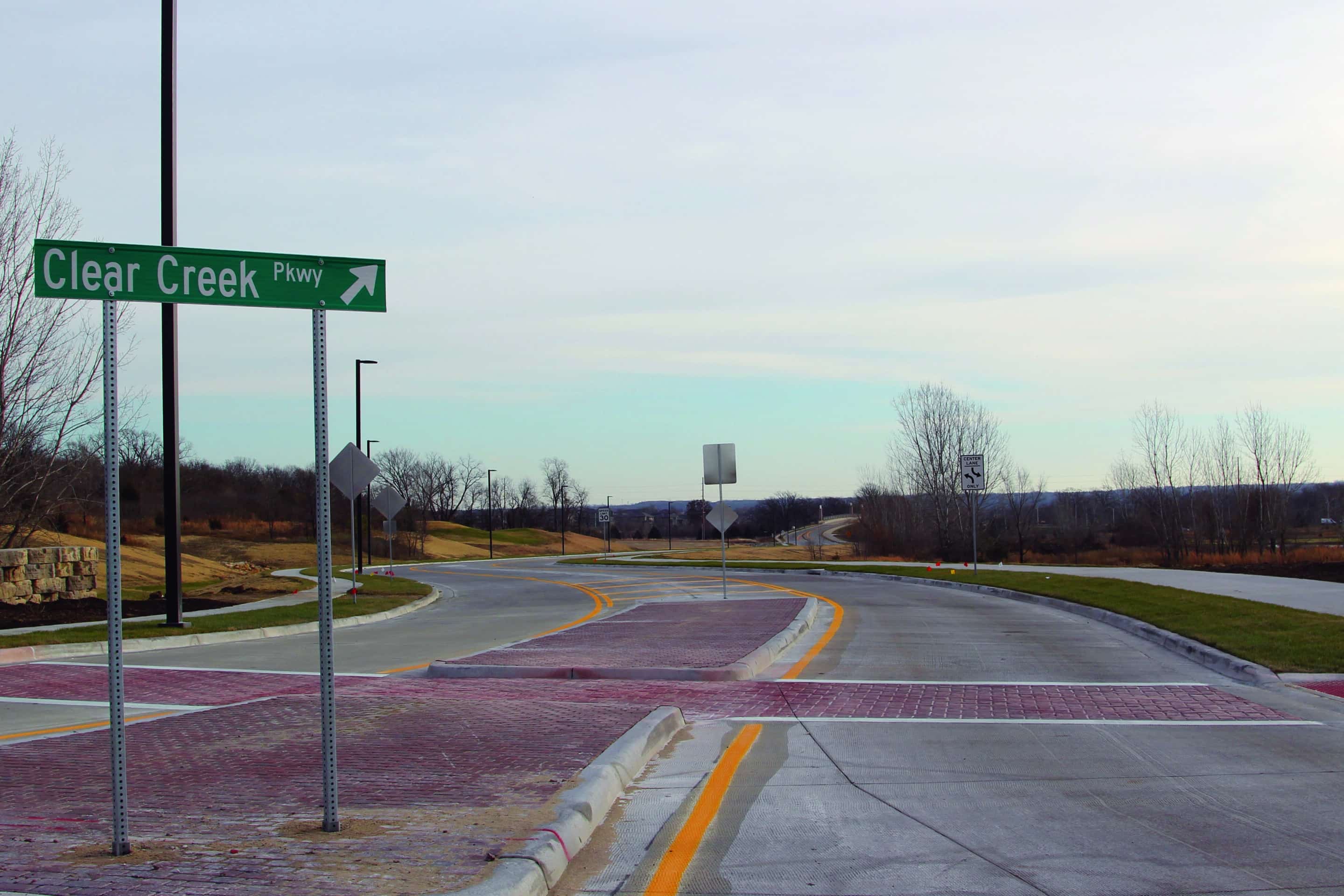 Clear Creek Parkway signage and colored concrete sidewalks.